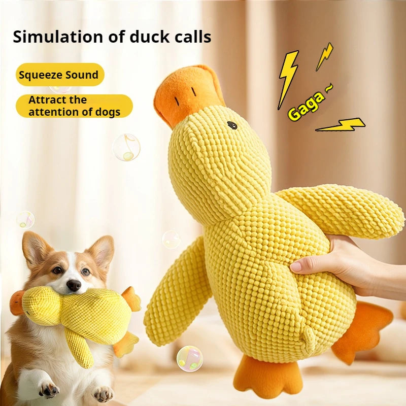 Yellow duck-shaped toy with orange accents, held by a person and played with by a dog, on a neutral background.